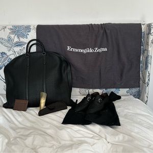 Ermenegildo Zegna black Pelletessuta garment bag with accessories.